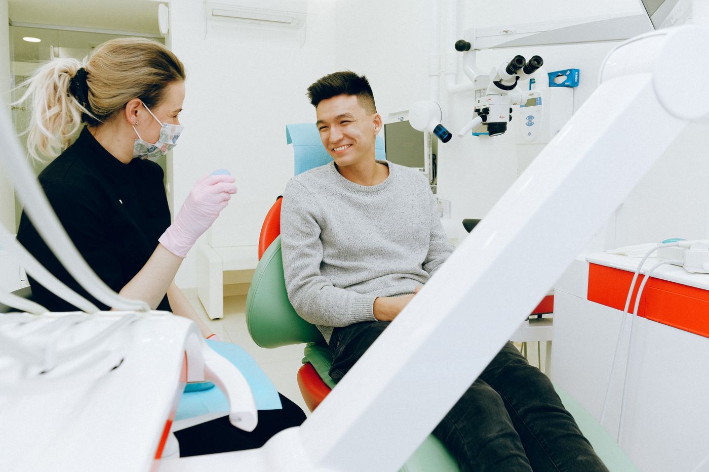 Consultation room — dentist and patient talking across a desk